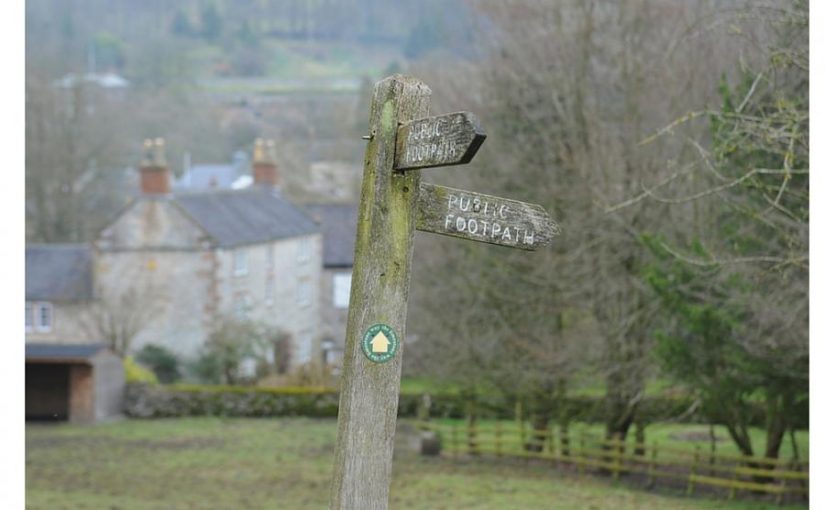 A footpath sign in rural England for an article on the best walks in England and Wales